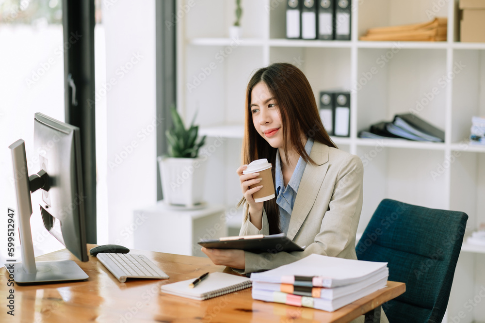 Business woman using tablet and laptop for doing math finance on an office desk, tax, report, accounting, statistics, and analytical research concept Business woman using tablet and laptop for doing math finance on an office desk, tax, report, accounting, statistics, and analytical research concept