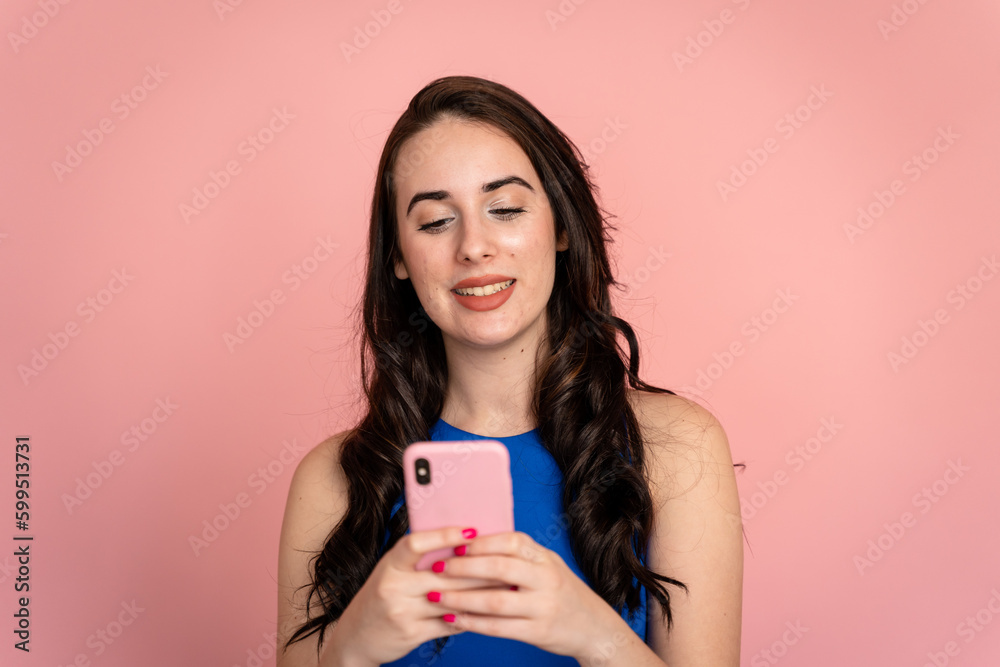 Smiling woman using a smartphone in a studio shot. Smiling woman using a smartphone in a studio shot.