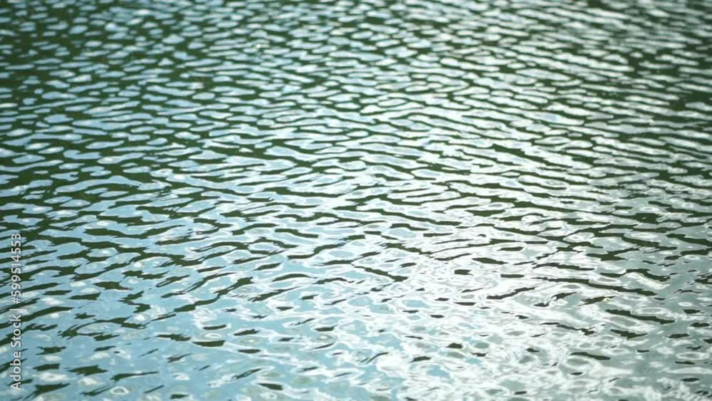 Sun reflecting on sparkling sea lake water surface, ocean at sunset, sunrise. Sunrays flickering in Ripples on water surface. Golden shimmering sea waves in sun. Slow motion. Abstract nautical nature Sun reflecting on sparkling sea lake water surface, ocean at sunset, sunrise. Sunrays flickering in Ripples on water surface. Golden shimmering sea waves in sun. Slow motion. Abstract nautical nature