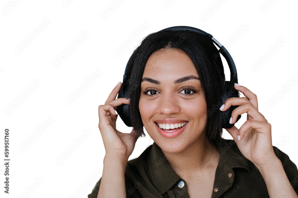 Close up African american young woman in headphones toothy smiling holding headset with excited expression. Mixraced woman enjoying music against transparent background. Call center employee