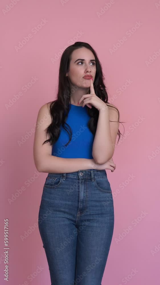 Woman showing doubt in a studio shot. Vertical video. Woman showing doubt in a studio shot. Vertical video.