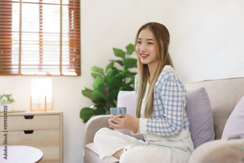 Leisure time concept, Women holding coffee cup and sitting on the couch to spending relax time