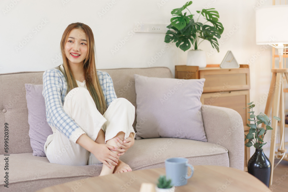 Rest time concept, Women are sitting on comfortable couch and looking outside to thinking something Rest time concept, Women are sitting on comfortable couch and looking outside to thinking something