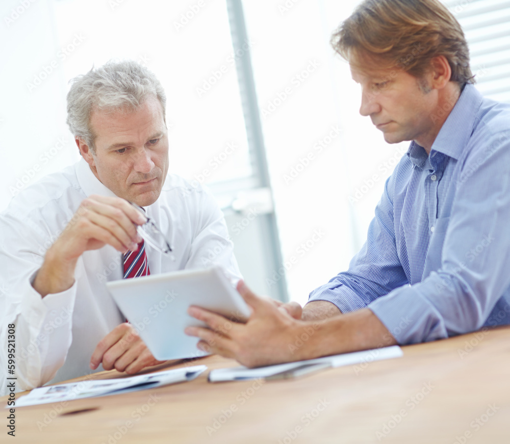 There could be improvements here. two businessmen sitting in an office and discussing the contents of the tablet. There could be improvements here. two businessmen sitting in an office and discussing the contents of the tablet.