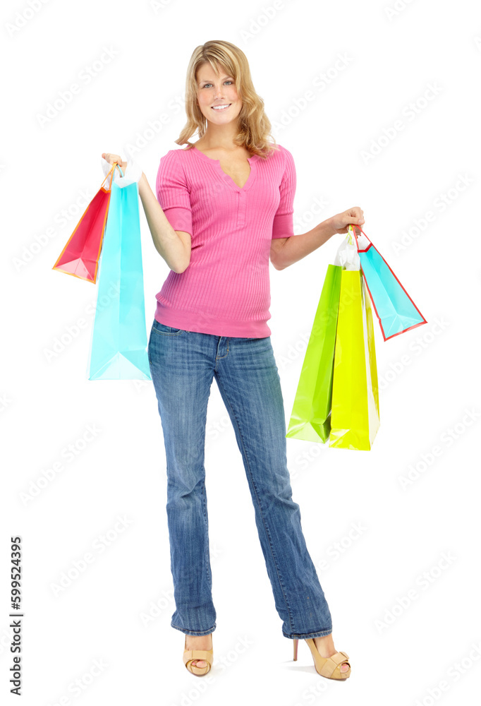 I might have over-indulged. Full length of a pretty young woman holding shopping bags while isolated on white.