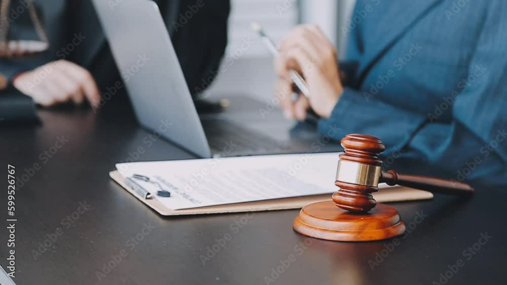 Business and lawyers discussing contract papers with brass scale on desk in office. Law, legal services, advice, justice and law concept picture with film grain effect Business and lawyers discussing contract papers with brass scale on desk in office. Law, legal services, advice, justice and law concept picture with film grain effect