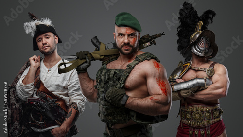 Studio shot of modern soldier with camouflage uniform with greek warrior and barbaric viking.