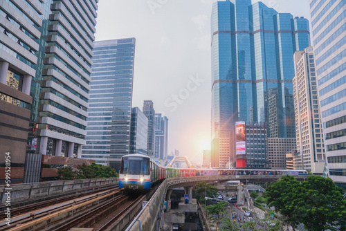 BTS Skytrain, Electric train, running on the way with business office buildings on the background.