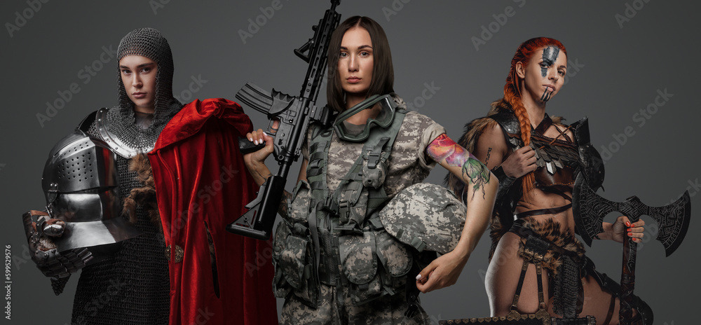 Studio shot of female soldier holding rifle with ancient amazon and knight woman. Studio shot of female soldier holding rifle with ancient amazon and knight woman.