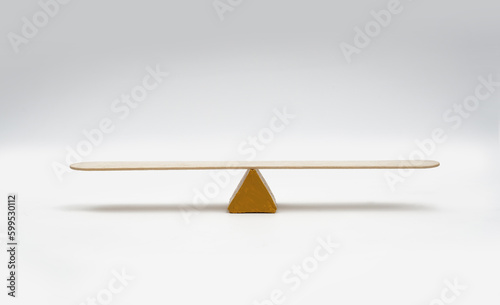Empty seesaw balancing on white background..