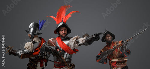 Photography Portrait of conquistadors with steel armor and plumed helemt holding flintlock guns