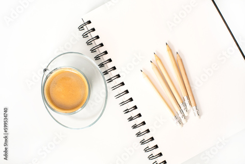 Notepad, pencils and cup of coffee