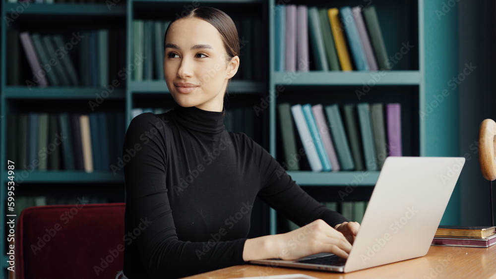 A smart modern student works in a new office, sits at a workplace and uses a laptop computer. In the library, a young woman is a man at work daily. A smart modern student works in a new office, sits at a workplace and uses a laptop computer. In the library, a young woman is a man at work daily.