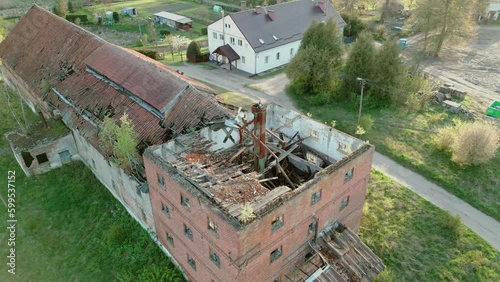 A dilapidated outbuilding with a collapsed tower photo