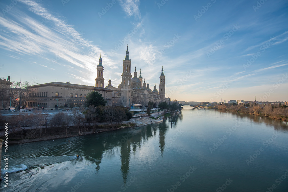 del Pilar basilica, one of the important architectural symbols of zaragoza, and the Ebro river and its reflection with sunset colors and clouds