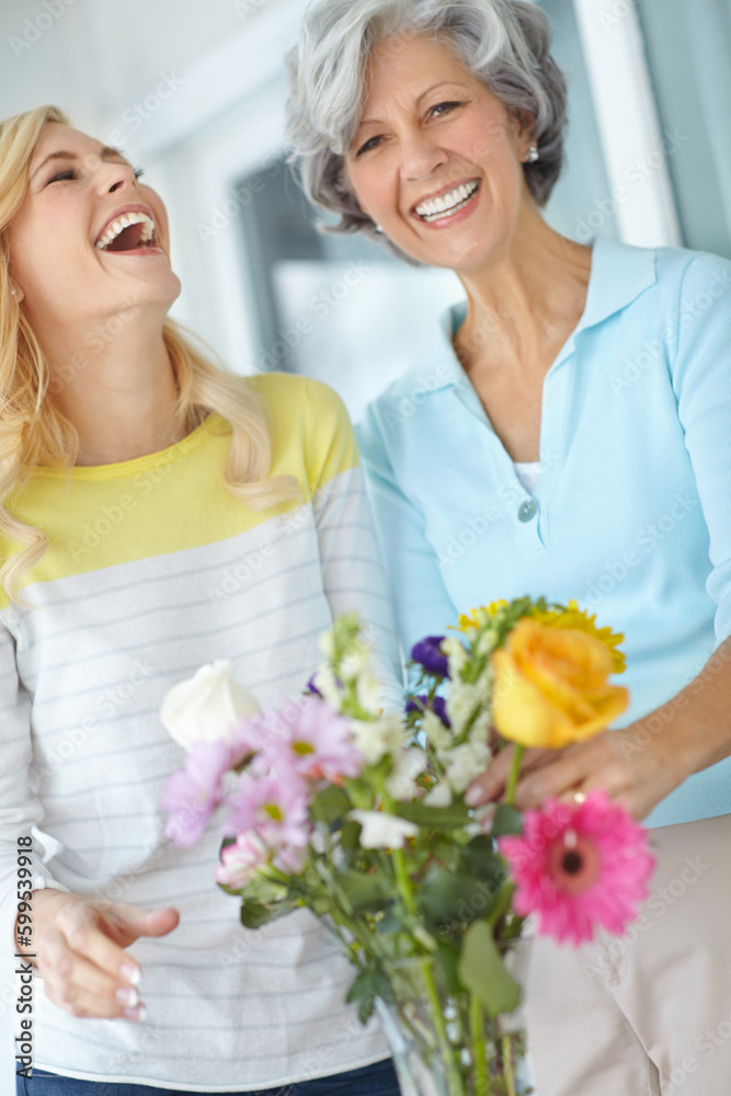 Having a laugh with Mom. Portrait of a senior woman enjoying some flower arranging with her daughter.