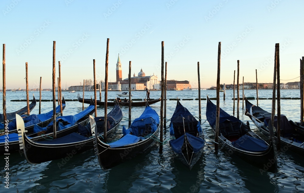 Gondolas standing on the pier in the Italian city of Venice