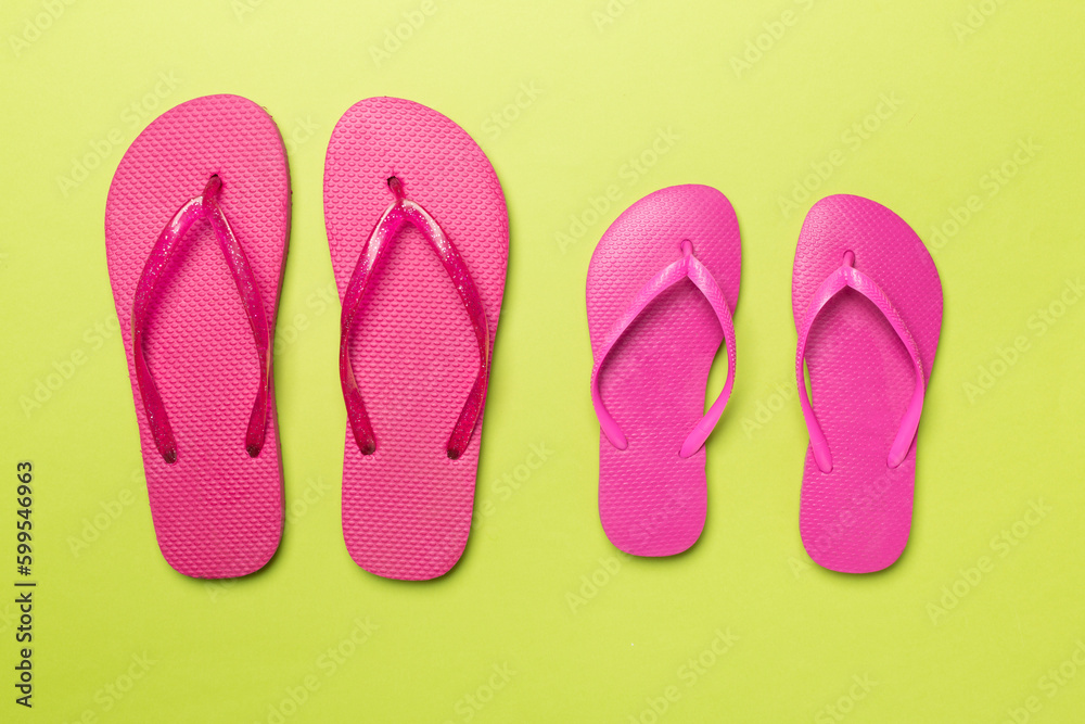 Many bright flip flops on color background, top view Many bright flip flops on color background, top view