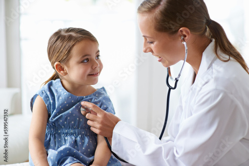 Woman, child and stethoscope of pediatrician for healthcare consulting, check lungs and listening to heartbeat. Medical doctor, girl kid and chest assessment in clinic, hospital and patient wellness photo