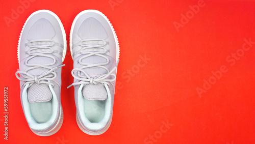 New Grey-light green sneakers isolated on red background. Unisex sports footwear, fashion style pair of casual sports shoes, Mock-up for sneaker design, logo, a product of sport. .
