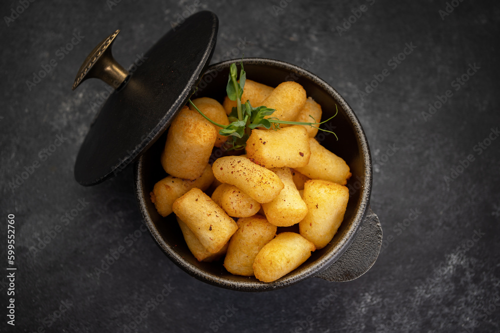 golden brown nuggets in a cast-iron dish on a stone golden brown nuggets in a cast-iron dish on a stone