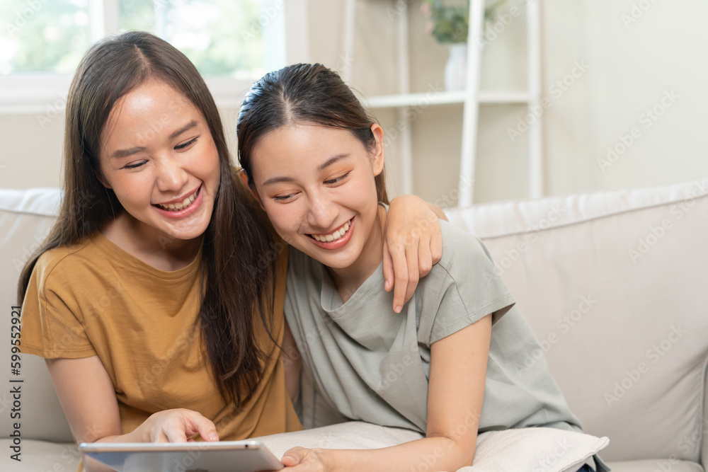 LGBT group. Good looking lesbian couples smile use tablet at home on holiday. Asian young couple hug each other happily, lover in love, bisexualities, homosexuality, liberty, expression, happy life LGBT group. Good looking lesbian couples smile use tablet at home on holiday. Asian young couple hug each other happily, lover in love, bisexualities, homosexuality, liberty, expression, happy life