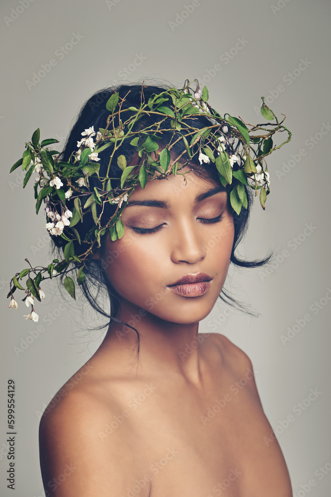 Beauty, flowers and crown with a woman in studio on a gray background for natural skincare or treatment. Skin, nature and wellness with an attractive young female model wearing a flower wreath