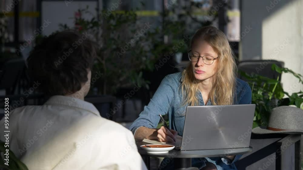 Slow motion camera shot of woman speaking in the meeting with her colleague. Job interview. Slow motion camera shot of woman speaking in the meeting with her colleague. Job interview.