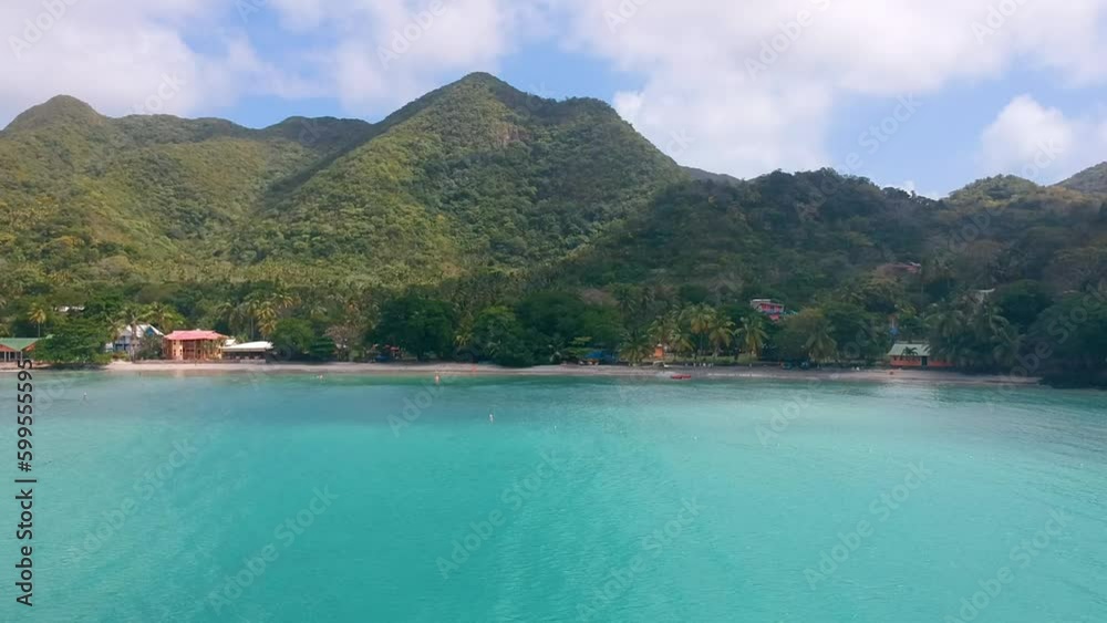 Beachfront Resort With Green Mountains And Calm Blue Sea In Providencia Island, Colombia. - aerial Beachfront Resort With Green Mountains And Calm Blue Sea In Providencia Island, Colombia. - aerial