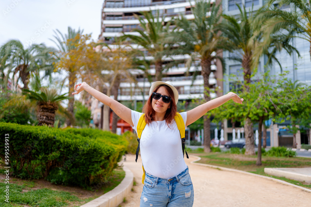 Fototapeta premium Happy traveler girl sightsees the city of Alicante Spain. lifestyle concept