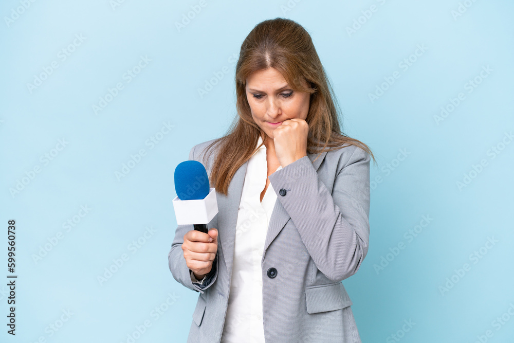 Middle-aged TV presenter woman over isolated blue background having doubts Middle-aged TV presenter woman over isolated blue background having doubts