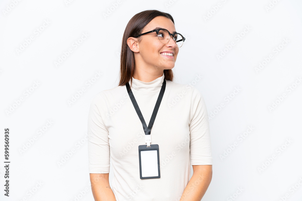 Young caucasian woman with ID card isolated on white background looking side