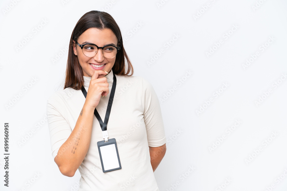 Young caucasian woman with ID card isolated on white background looking to the side and smiling Young caucasian woman with ID card isolated on white background looking to the side and smiling