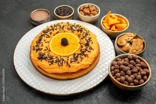 front view delicious pie with orange slices on dark background tea biscuit fruit dessert pie cake