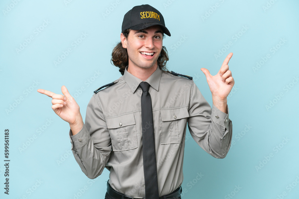 Young safeguard man isolated on blue background pointing finger to the laterals and happy Young safeguard man isolated on blue background pointing finger to the laterals and happy