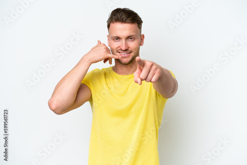 Young blonde caucasian man isolated on white background making phone gesture and pointing front