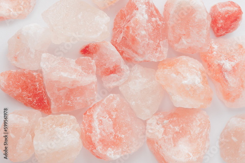 Raw rose quartz crystal stones on white