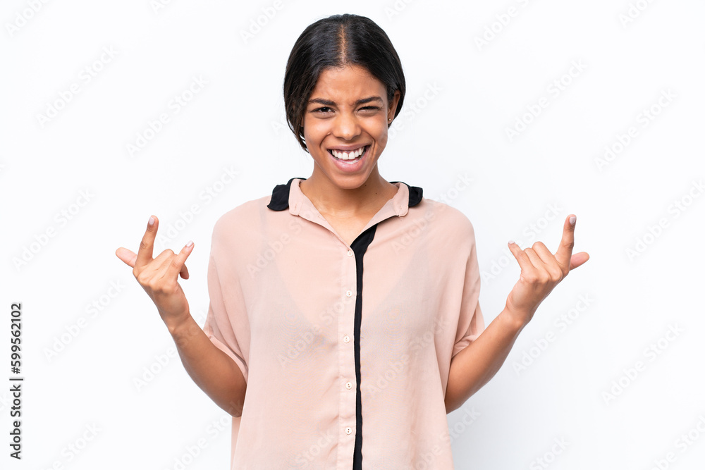 Young African american woman isolated on white background making horn gesture Young African american woman isolated on white background making horn gesture