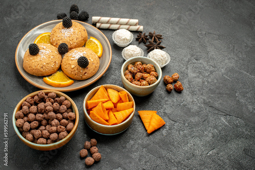 front view delicious sand cookies with chips and orange slices on a dark background sweet fruit cockie biscuit