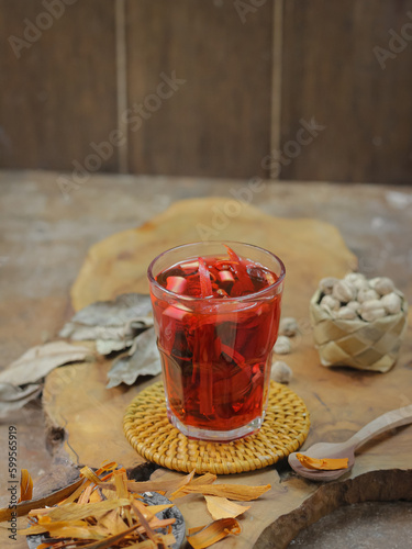 Wedang Uwuh, Traditional Warm Drink from Yogyakarta. Made with Various Spice. Served on a Glass with Rock Sugar photo