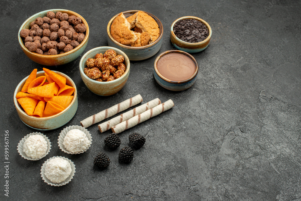 front view orange cips with sweet nuts and chocolate flakes on a dark grey background meal snack breakfast nut front view orange cips with sweet nuts and chocolate flakes on a dark grey background meal snack breakfast nut