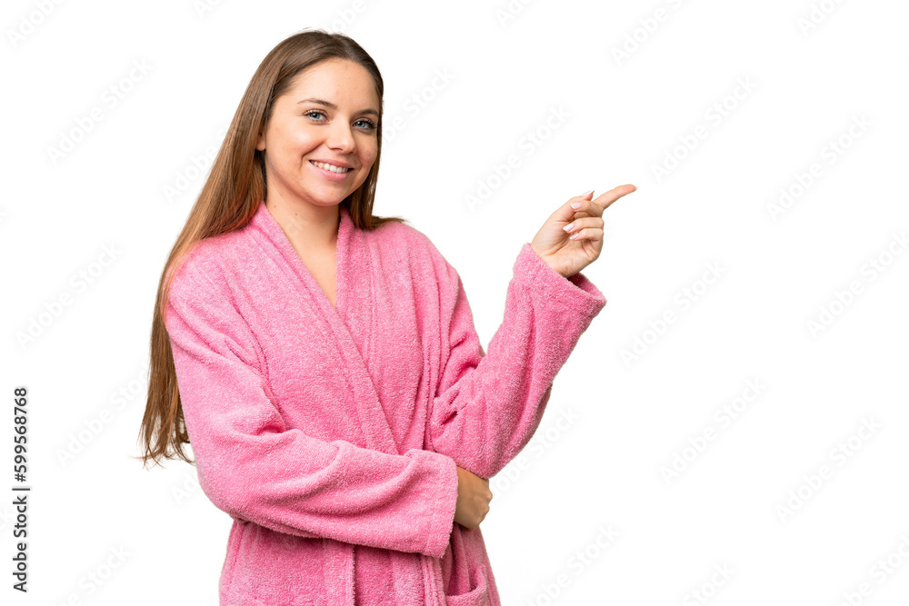 Young woman in a bathrobe over isolated chroma key background pointing finger to the side Young woman in a bathrobe over isolated chroma key background pointing finger to the side