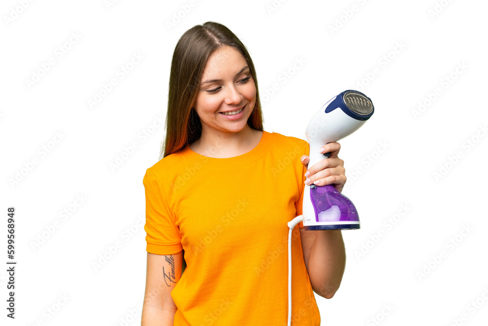 Young blonde woman holding a vertical steam iron over isolated chroma key background with happy expression Young blonde woman holding a vertical steam iron over isolated chroma key background with happy expression