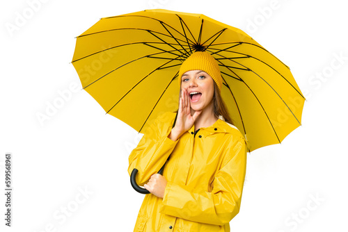 Young blonde woman with rainproof coat and umbrella over isolated chroma key background shouting with mouth wide open