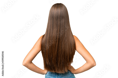 Teenager caucasian girl over isolated background in back position