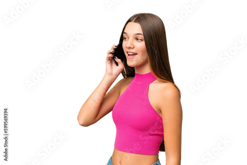 Teenager caucasian girl over isolated background keeping a conversation with the mobile phone