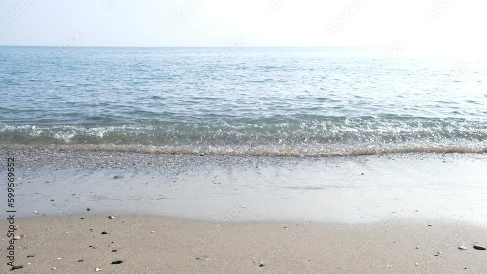 Waves of Sea rolling to sandy beach. Blur high wave. Close-up shot of calming foamy water. Wave runs on sandy shore of sea. Calm ocean water waves splashing sandy beach. Waves breaking sand beach. Waves of Sea rolling to sandy beach. Blur high wave. Close-up shot of calming foamy water. Wave runs on sandy shore of sea. Calm ocean water waves splashing sandy beach. Waves breaking sand beach.