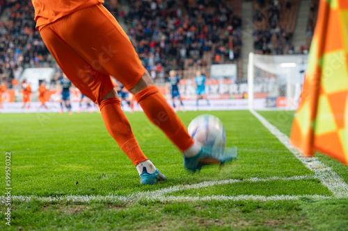 Footballer takes the corner. Detail of player's legs and the ball during soccer match. © Dziurek