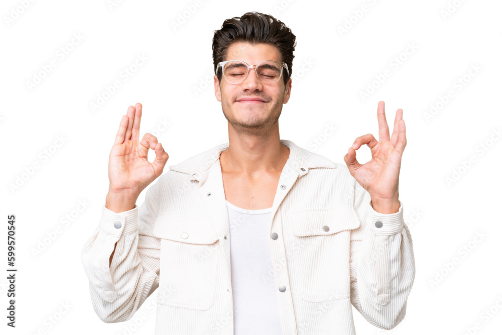 Young handsome caucasian man over isolated background in zen pose Young handsome caucasian man over isolated background in zen pose
