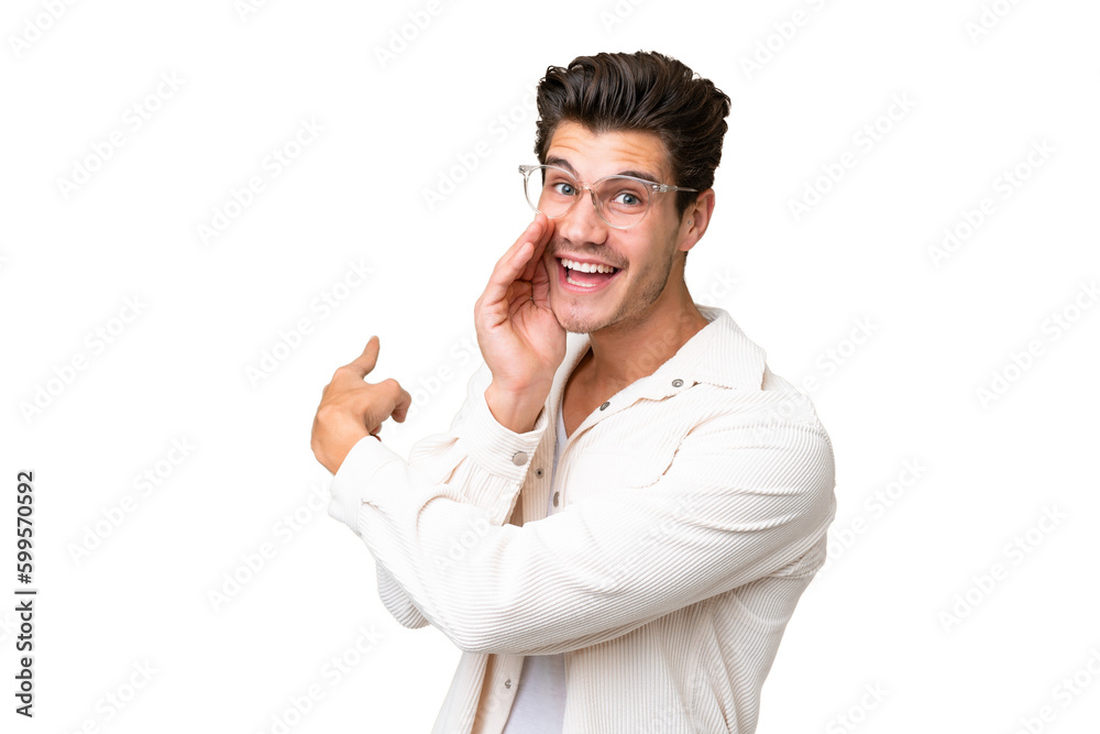 Young handsome caucasian man over isolated background pointing to the side to present a product and whispering something Young handsome caucasian man over isolated background pointing to the side to present a product and whispering something